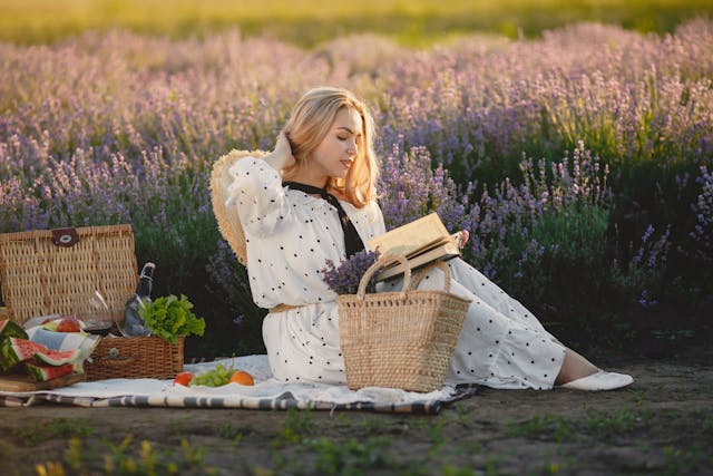 a-woman-reading-a-book-while-sitting-on-a-picnic-blanket-pexels-gustavo-fring-4971448